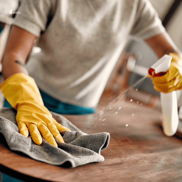 a woman cleaning a table