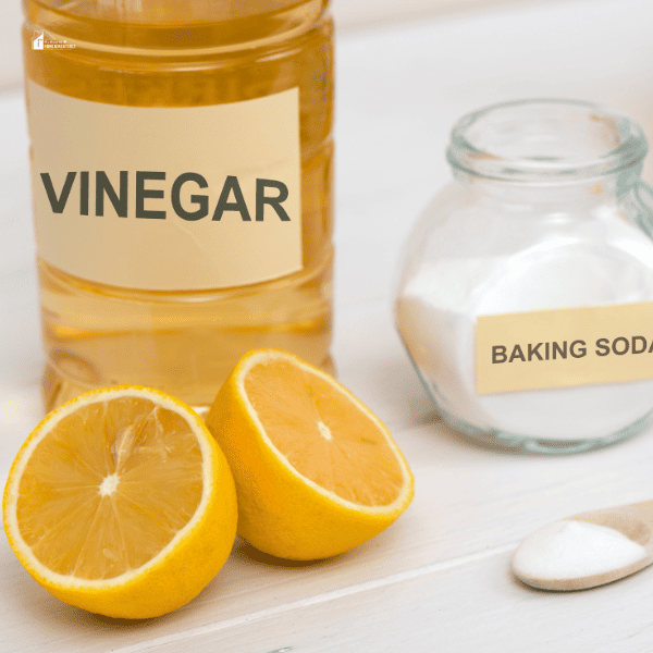 an image of a vinegar with baking soda and lemon beside it