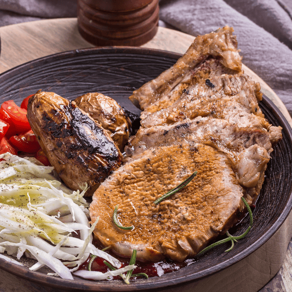 Rustic baked pork chops with potato.