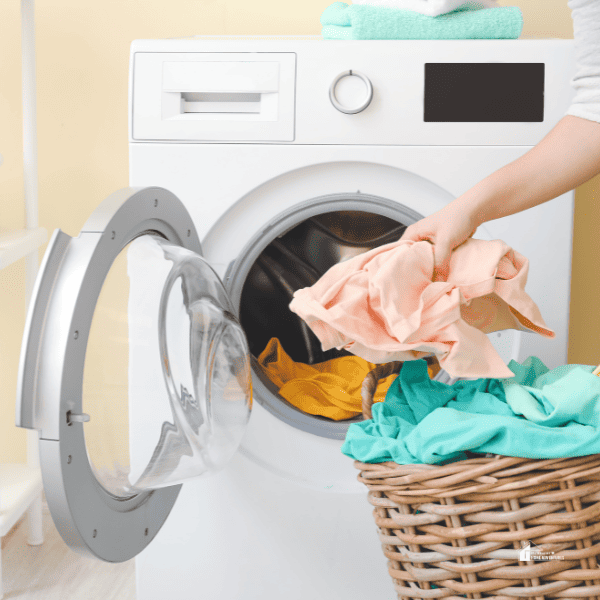 young women doing laundry at home