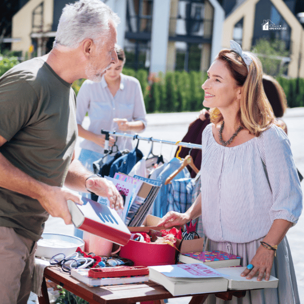 bearded man talking to a woman in a yard sale