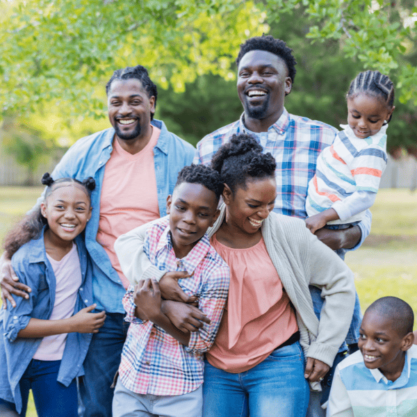 Black family with aunts and uncles and cousins enjoying a reunion.