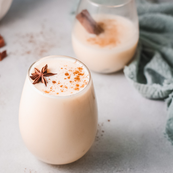 Closeup of eggnog served with a another glass in the background