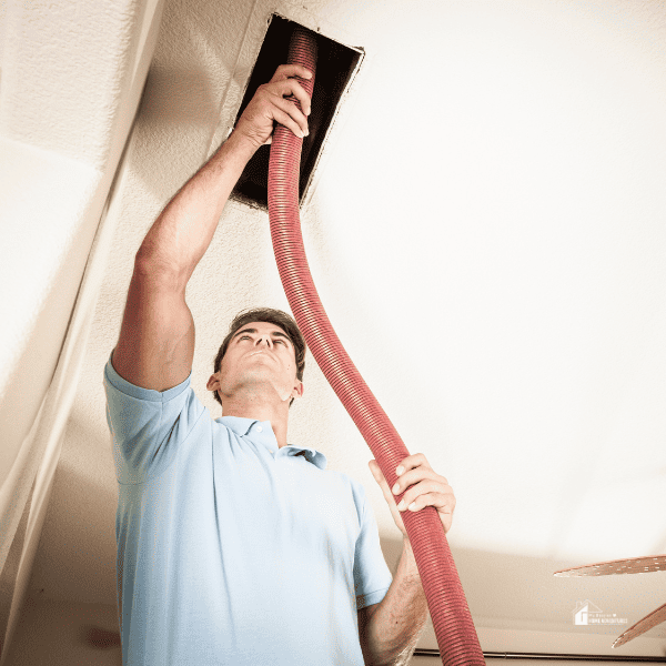 man Cleaning Air Ducts at home