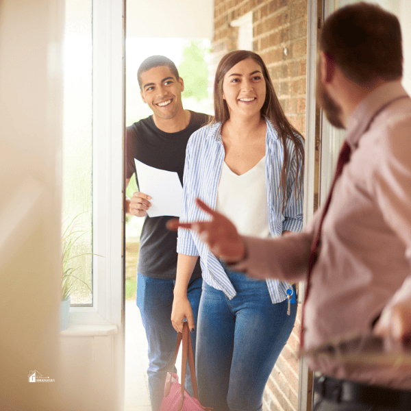 couple standing in the front door of a house