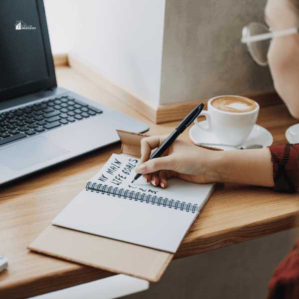 Young woman writing in notebook life goals