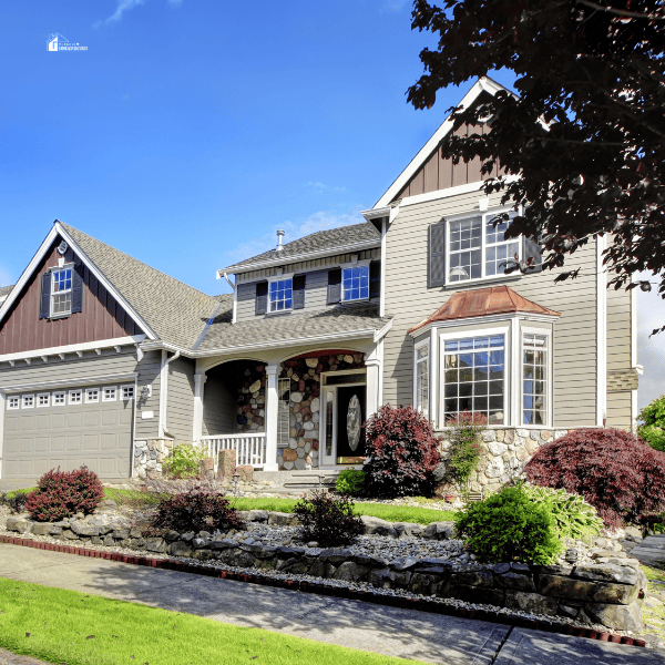 Modern home with navy blue door and decorative front yard