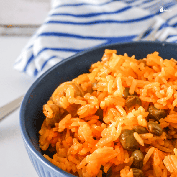 an image of Arroz Con Grandules in a blue bowl