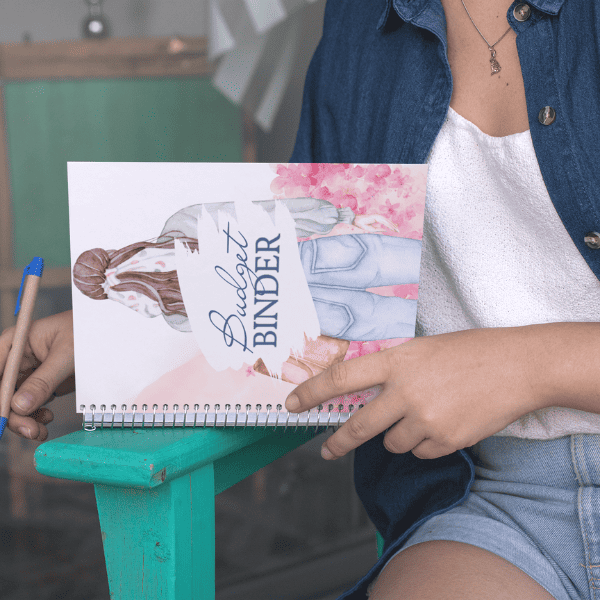 woman using a budget notebook