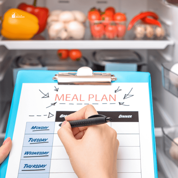 Woman Making Meal Plan in Kitchen