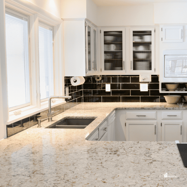 A modern kitchen with white cabinets and countertop