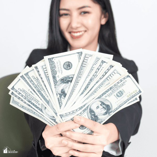An image of a woman holding $100 bills.