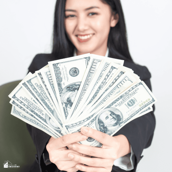 An image of a woman holding dollar $100 bills.
