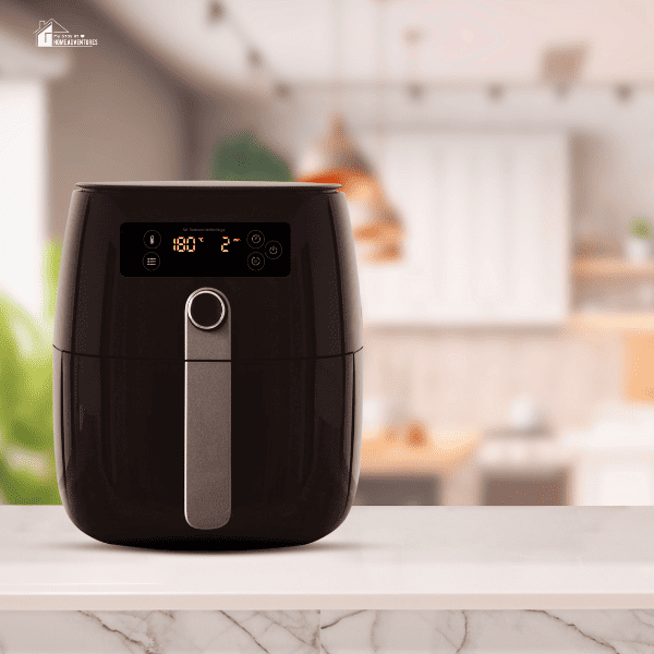 air fryer with a kitchen blurred behind it