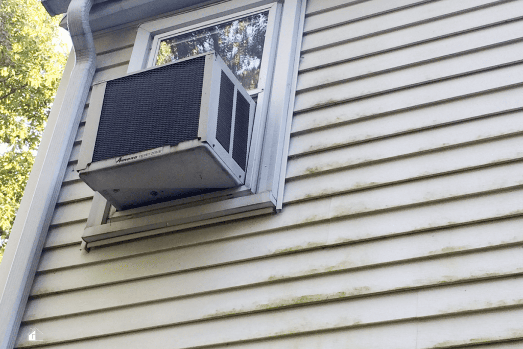 Air conditioner window unit with moldy on vinyl siding