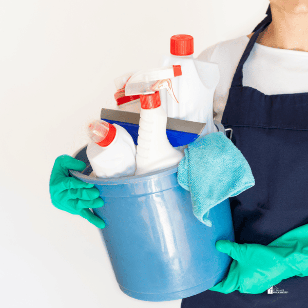 Cleaning Lady Holding Cleaning Bucket with glove and bleach