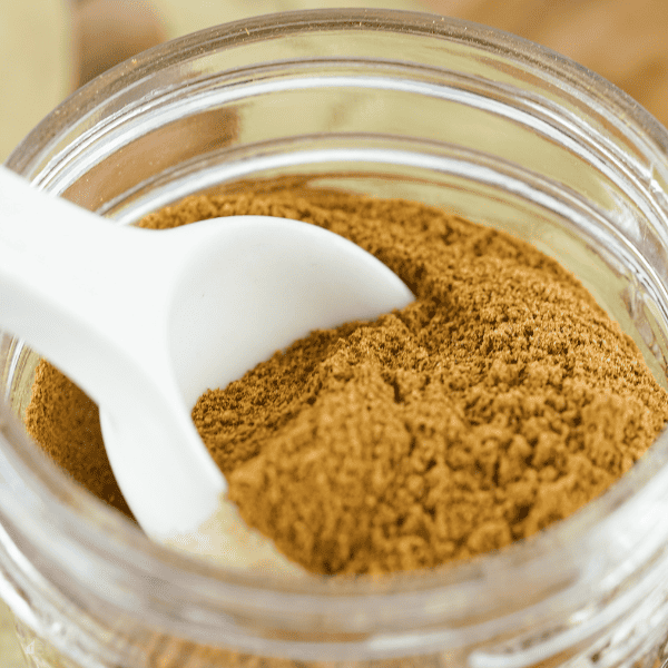 A close-up of a jar filled with homemade apple pie spice, ready to be used in fall dessert ideas and apple pie seasoning recipes. Learn how to make apple pie spice for your favorite homemade dry mixes.