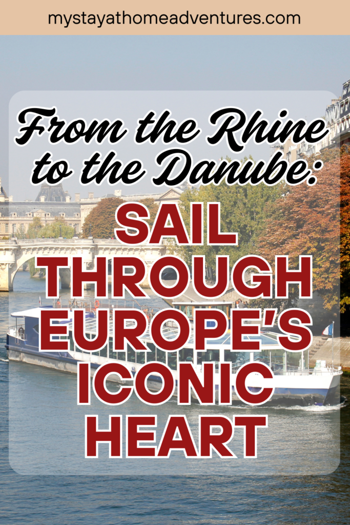 A riverboat sails through a scenic European city with classic architecture and vibrant fall foliage lining the waterway.