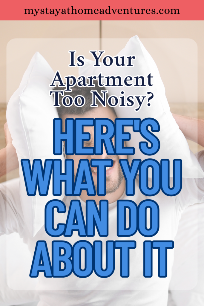A man lies in bed pressing pillows against his ears to block out disruptive apartment noise in a bright bedroom setting.