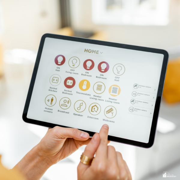 A close-up of a tablet displaying a smart home control dashboard with various lighting and room settings.