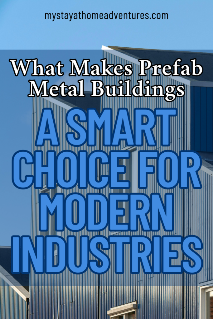 Several modern prefabricated metal buildings with vertical paneling and sharp rooflines against a clear blue sky.