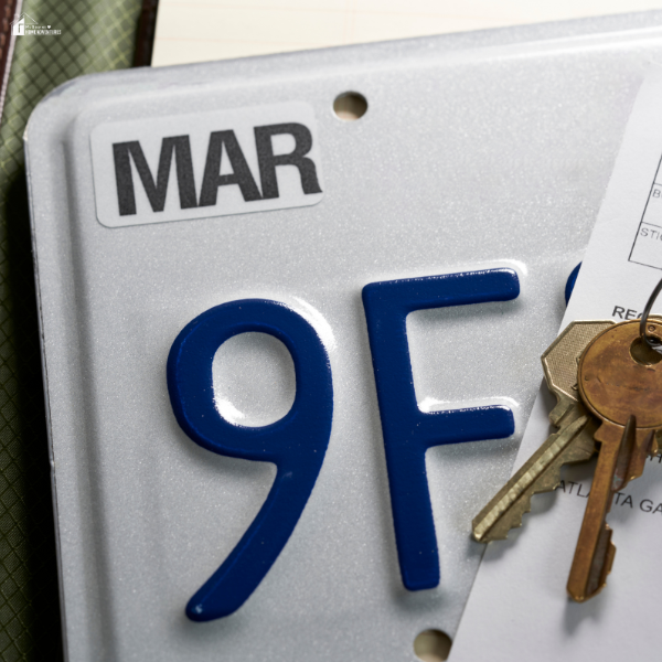 A close-up of a license plate with attached car keys, symbolizing vehicle ownership and the customization options car lovers value.