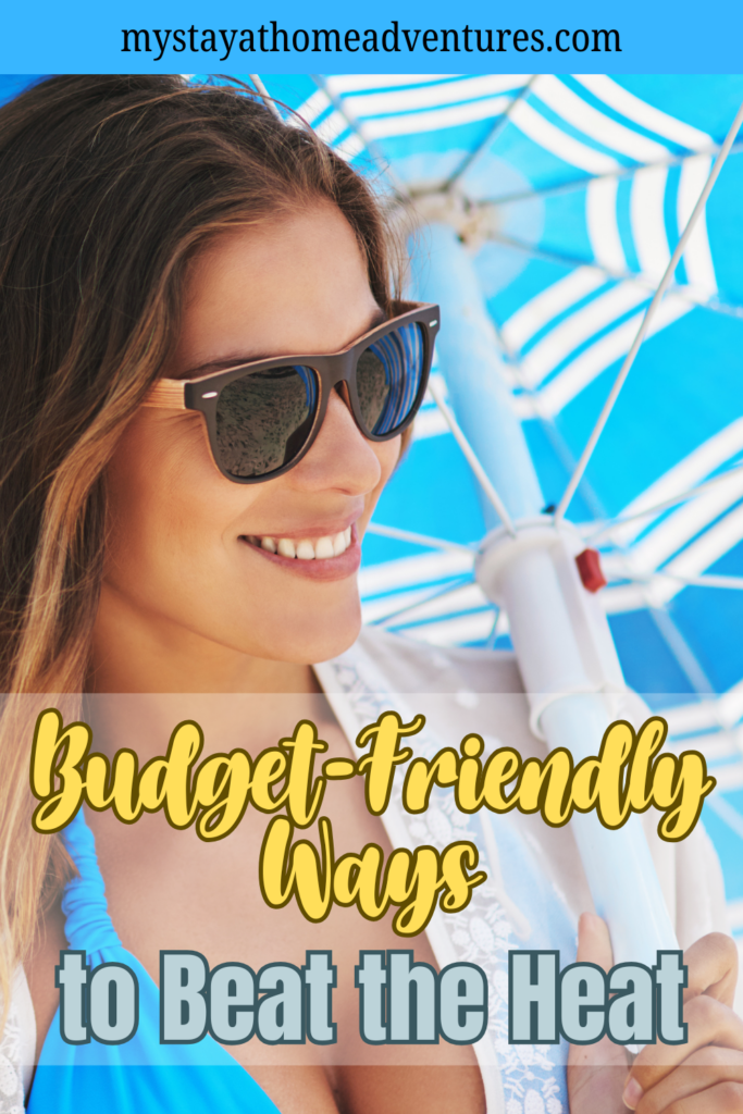 A woman stays cool and stylish under a beach umbrella, showing a simple way to beat the heat without overspending.