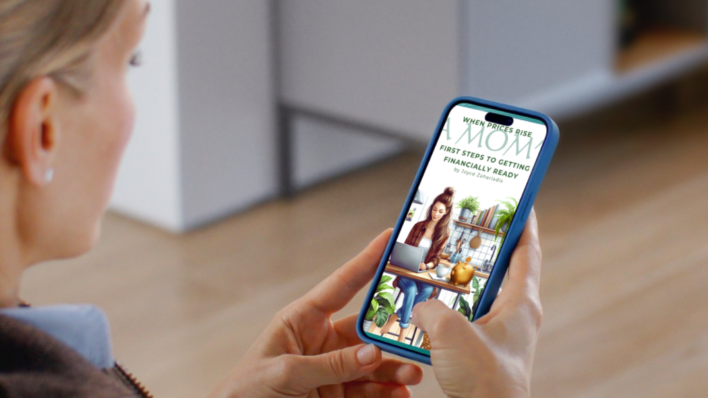A woman holding a smartphone displaying the cover of the ebook “When Prices Rise: A Mom’s First Steps to Getting Financially Ready” by Joyce Zahariadis.