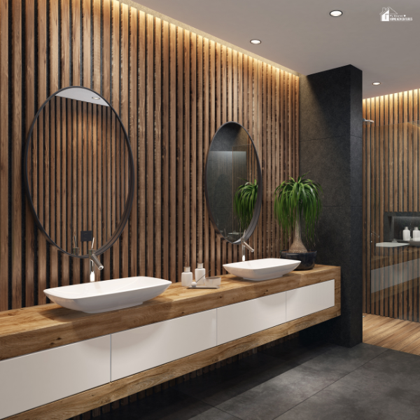 Modern bathroom with wooden accent wall, dual vessel sinks, and large round mirrors creating a spa-like look.