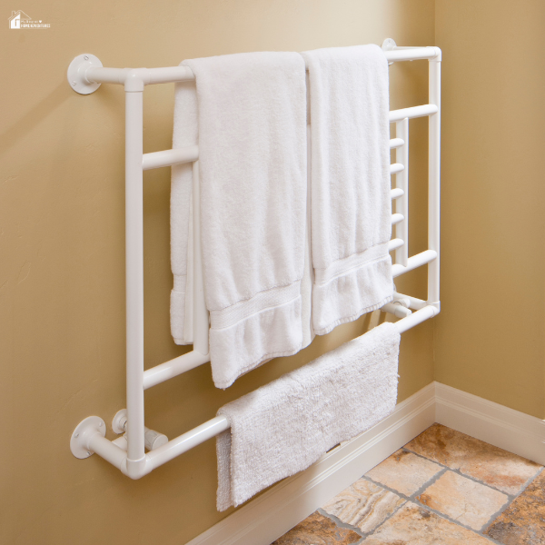 White towels hanging neatly on a wall-mounted towel warmer in a bathroom.
