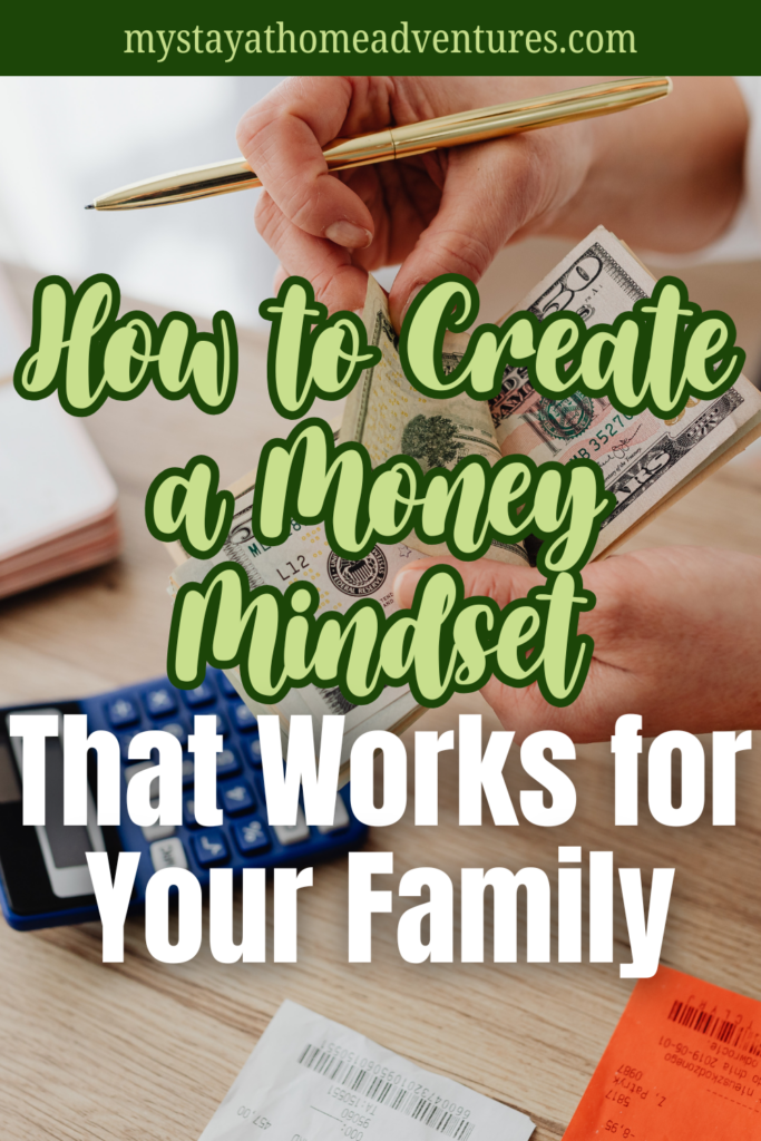 Close-up of hands holding cash and a pen with a calculator and receipts on a desk.