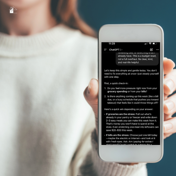 Woman holding a smartphone displaying the free Budget Reset Chat in ChatGPT, showing simple step-by-step budgeting guidance for moms to manage money stress.