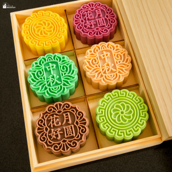 A wooden gift box filled with six colorful mooncakes in different designs and flavors.