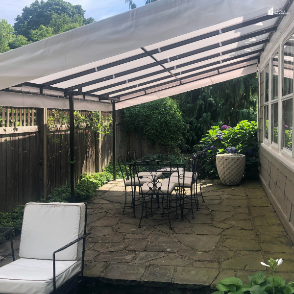 A backyard patio with outdoor furniture under an awning, showing upkeep and maintenance of a home.