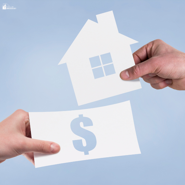 Two hands exchange paper cutouts of a house and a dollar symbol, symbolizing financial planning.