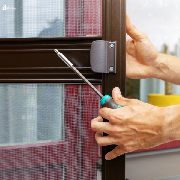 Person tightening a screw with a screwdriver to attach a magnetic screen door for added convenience.
