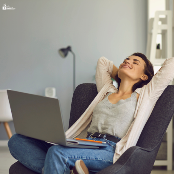 A relaxed woman leans back in a chair with a smile, representing the satisfaction that comes from waiting for positive results.