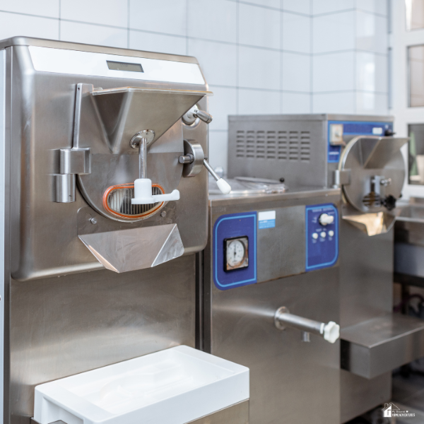 Commercial snowflake ice cream machines made of stainless steel inside a professional kitchen.