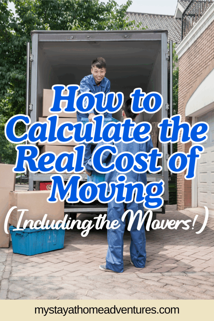 Mover passes a cardboard box to a coworker from the back of a truck parked outside a brick home on moving day.