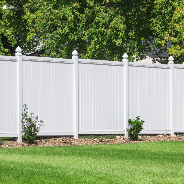 White WPC privacy fencing surrounds a landscaped yard, highlighting eco-friendly home improvement.