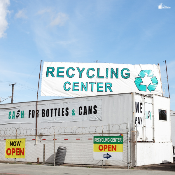 A recycling center displays signs for bottle and can return, promoting eco-friendly waste management.