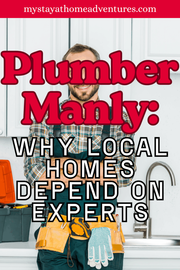 A professional plumber in work clothes standing in a modern kitchen with tools around him.