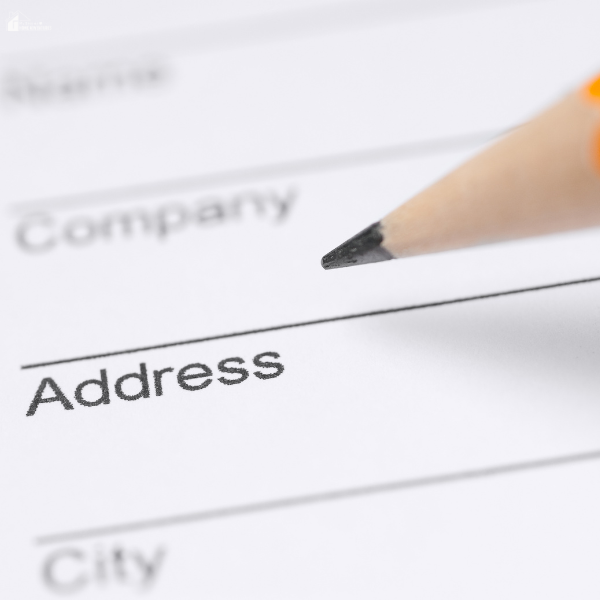 A pencil points to the word "Address" on a printed form, representing moving-related paperwork.