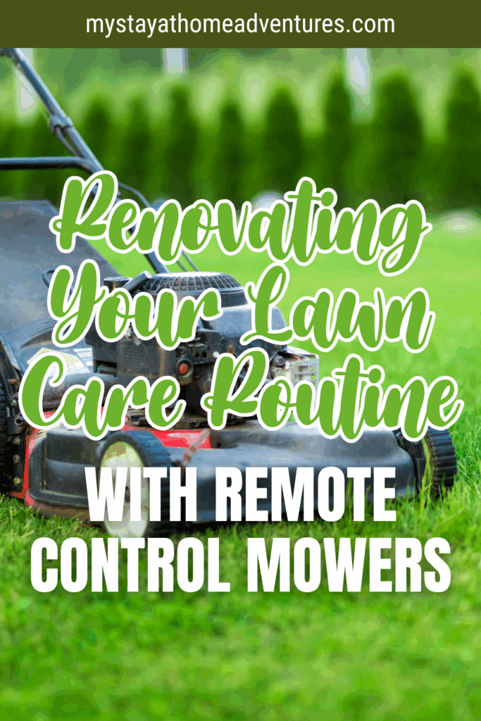 A remote control lawn mower resting on bright green grass in a neatly trimmed yard with trees in the background.