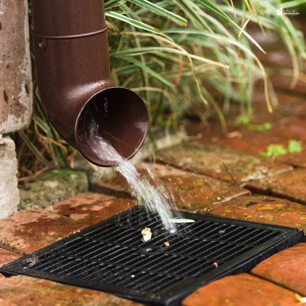 A gutter downspout draining water efficiently, showing how proper drainage systems protect your home year-round.