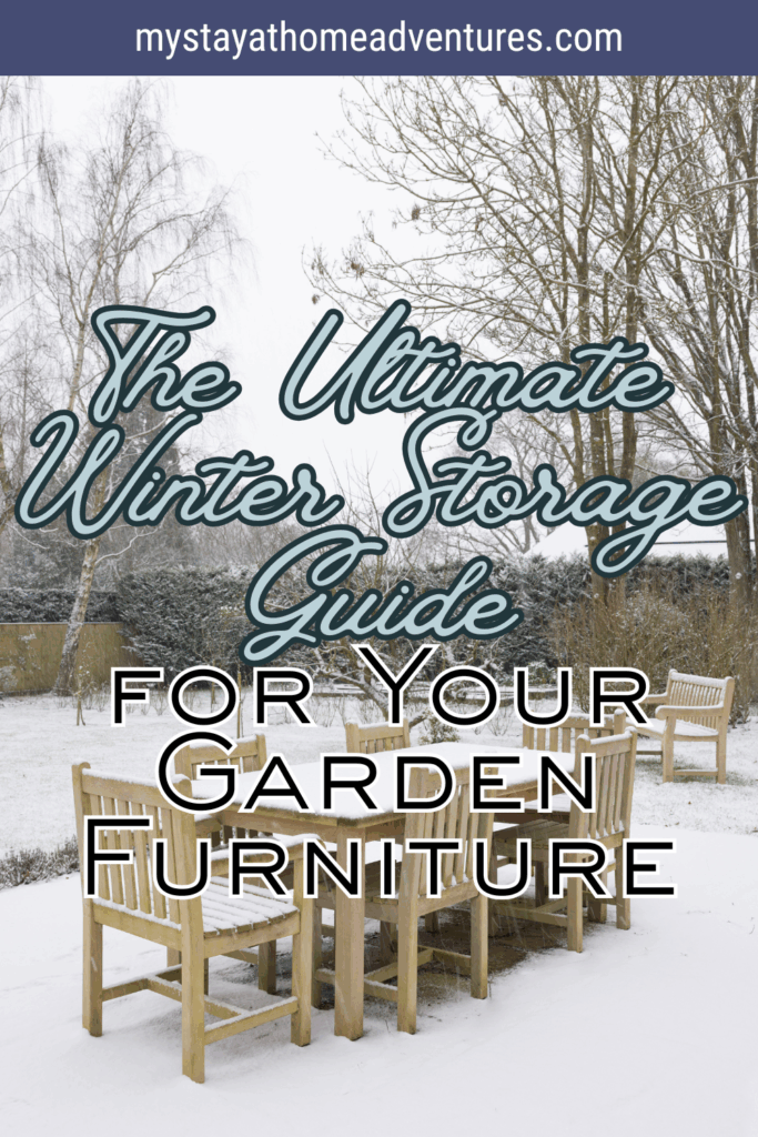 Wooden garden furniture set sitting on a snow-covered lawn with bare trees and evergreen shrubs in the background.