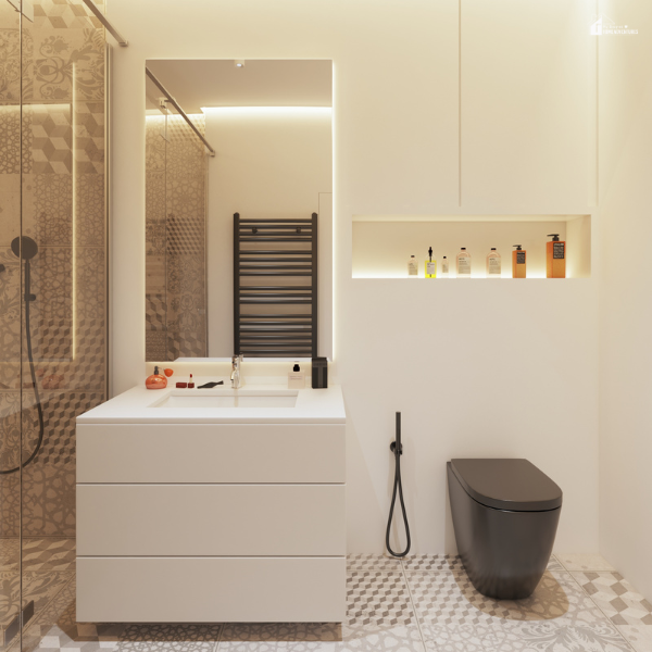 A sleek rectangular mirror reflects warm lighting in a minimalist bathroom with a black toilet and patterned tile flooring.