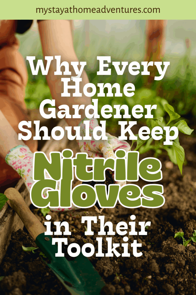 A close-up of hands wearing floral nitrile gloves working in soil near green plants with a small garden spade.