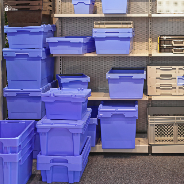 A shelving unit filled with various sizes of plastic storage bins for home organization and labeling.