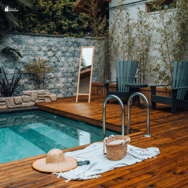 A cozy modern backyard pool with a wooden deck, perfect for enjoying a quiet staycation at home.
